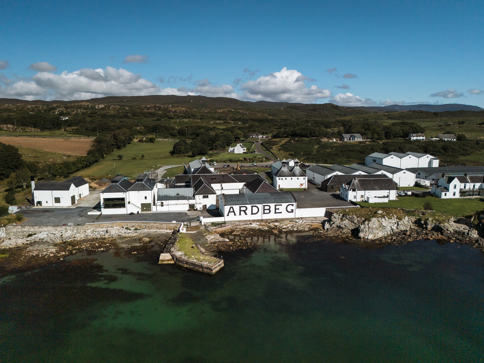 Ardbeg Distillery beside the Islay shoreline, photographed from above
