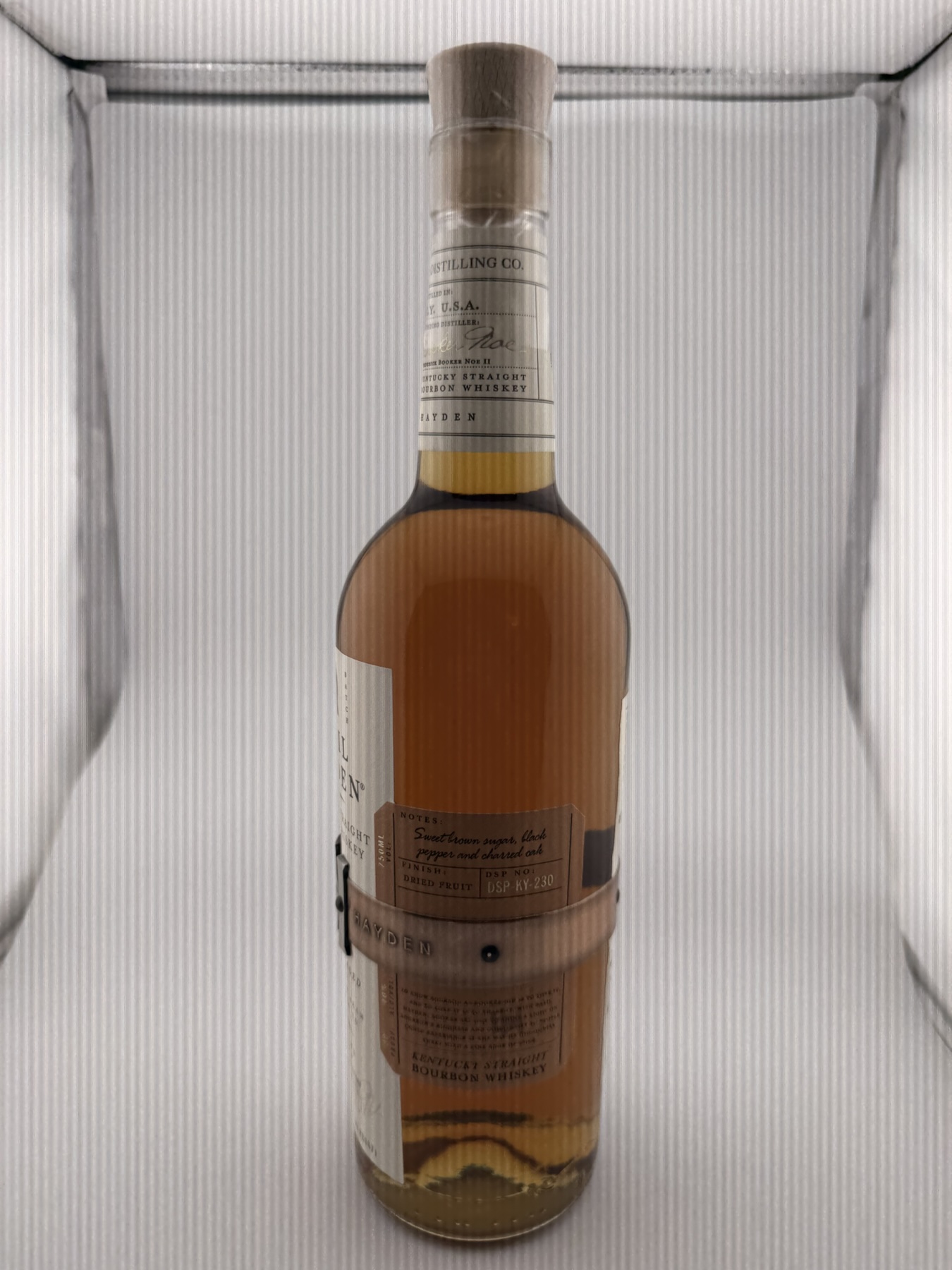 Side of the Basil Hayden bottle showing the printed notes panel and band