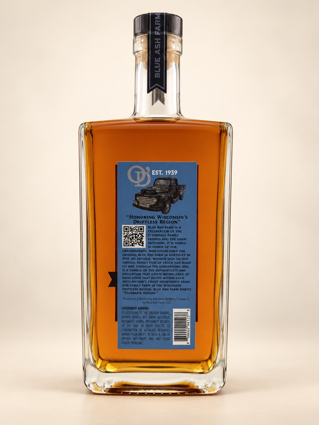 Back of the Blue Ash Farm Bourbon bottle with a vintage truck illustration and producer information