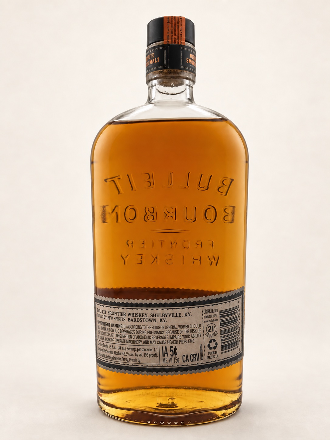 Back of the Bulleit Mesquite Smoked Malt bottle, showing its wraparound label and reversed embossing through the whiskey